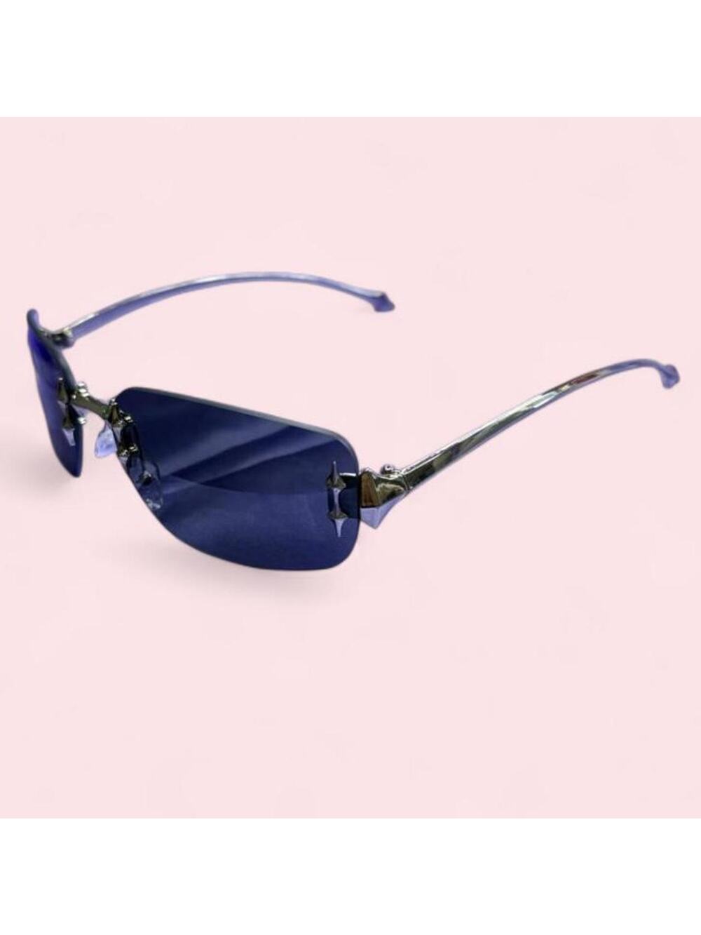 Futuristic rimless shield sunglasses with silver spike/star hardware details
